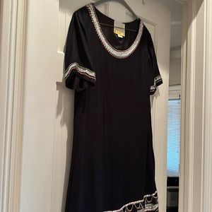 Fun and flattering black shift dress with great heading detail.